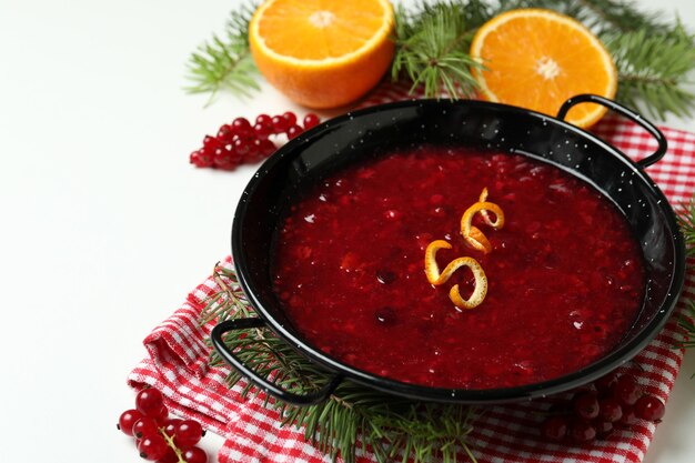 Concept of tasty food with cranberry sauce on white background