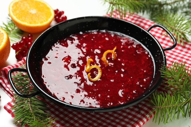 Concept of tasty food with cranberry sauce on white background