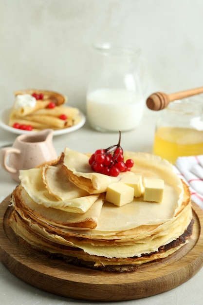 Concept of tasty food with crepes on light textured table