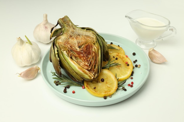 Concept of tasty food with grilled artichoke on white background