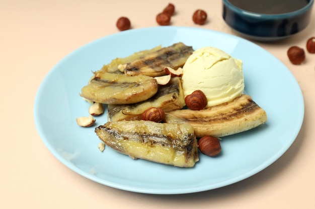 Concept of tasty food with grilled banana on beige background