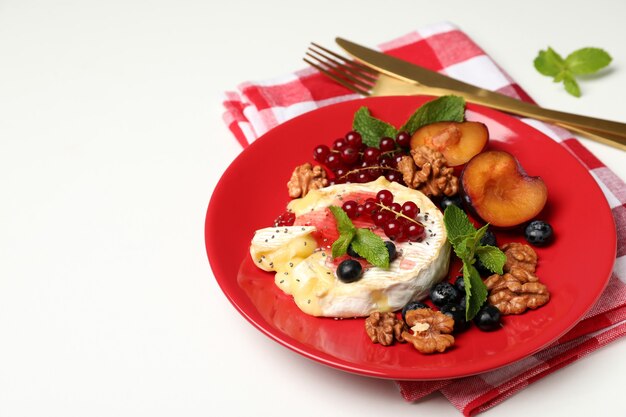 Concept of tasty food with grilled camembert on white background.