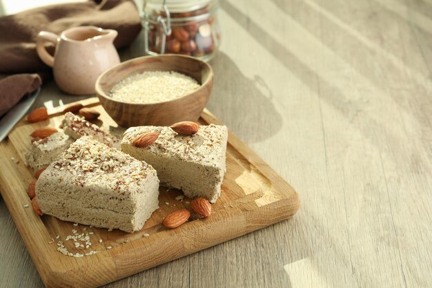 Concept of tasty food with halva on wooden background