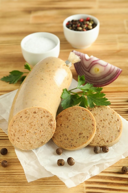 Concept of tasty food with liverwurst sausage on wooden table