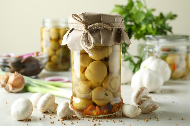 Concept of tasty food with marinated mushrooms on white textured table