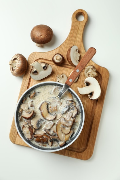 Concept of tasty food with mushroom sauce on white background