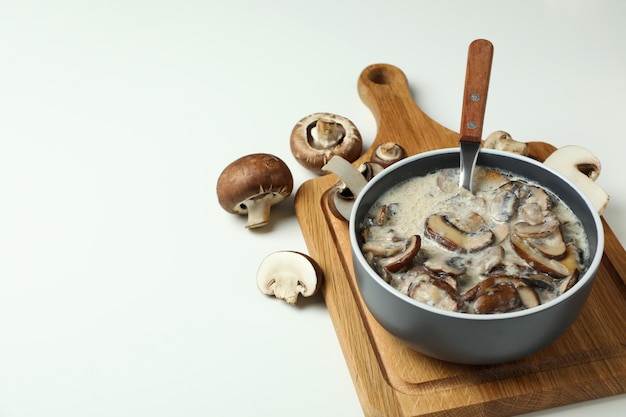 Concept of tasty food with mushroom sauce on white background