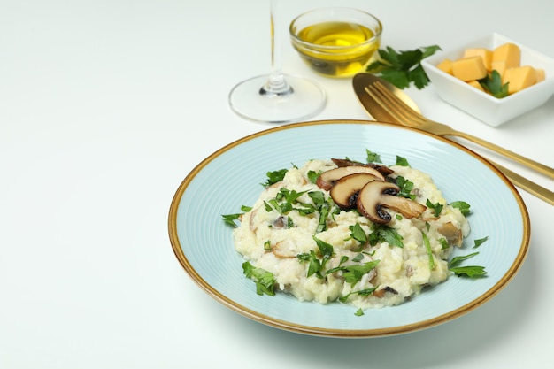 Concept of tasty food with risotto with mushrooms on white background