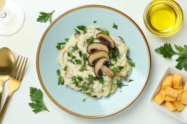 Concept of tasty food with risotto with mushrooms on white background