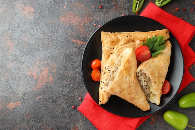 Concept of tasty food with samsa on dark textured background