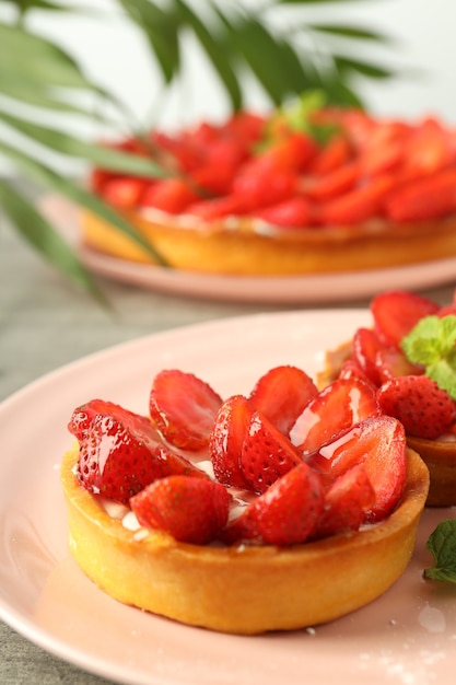 Concept of tasty food with strawberry tarts, close up.