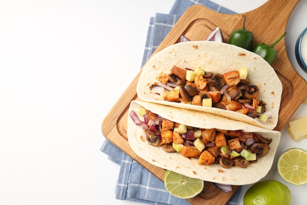 Concept of tasty food with taco on white background