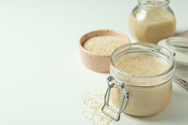 Concept of tasty food with tahini sauce on white background