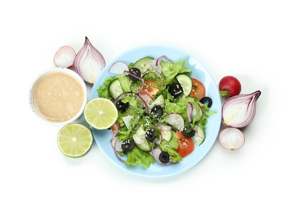 Concept of tasty food with vegetable salad with tahini sauce isolated on white background