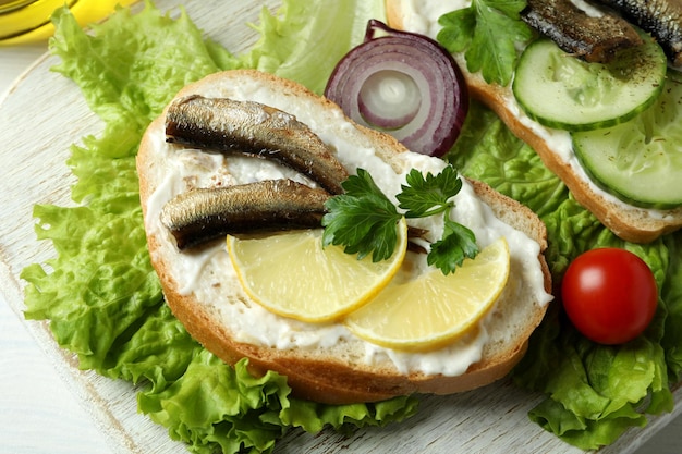 Concept of tasty snack with sandwiches with sprats, close up