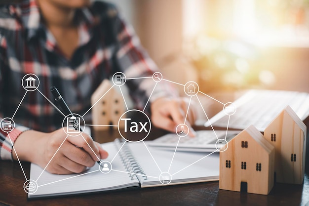 Concept of tax payment optimisation business financeMan using calculator and taxes icon on technology screenincome tax and property background for business individuals and corporations such as VAT