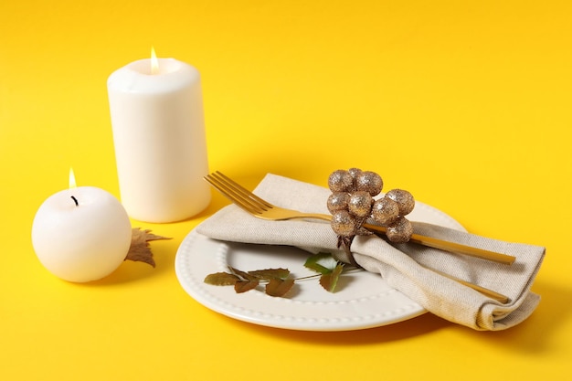 Concept of Thanksgiving day Autumn table setting on yellow background