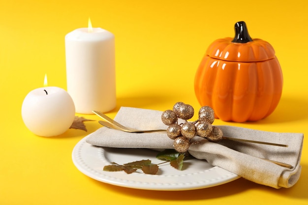 Concept of Thanksgiving day Autumn table setting on yellow background