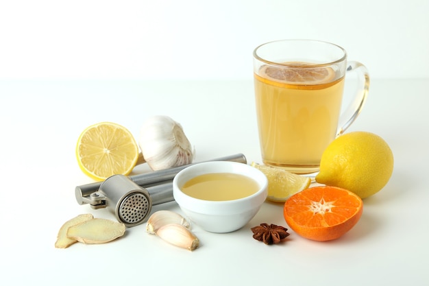 Concept of treatment colds with honey and garlic on white background