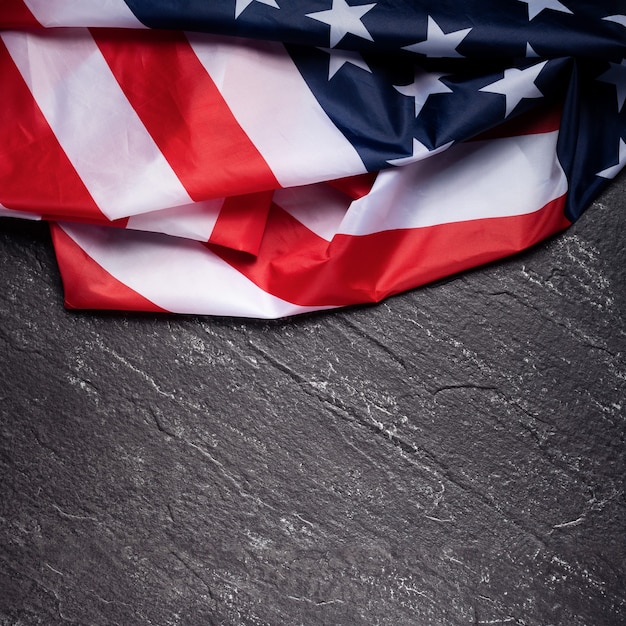 Concept of U.S Independence day or Memorial day. National flag over dark slate table background.