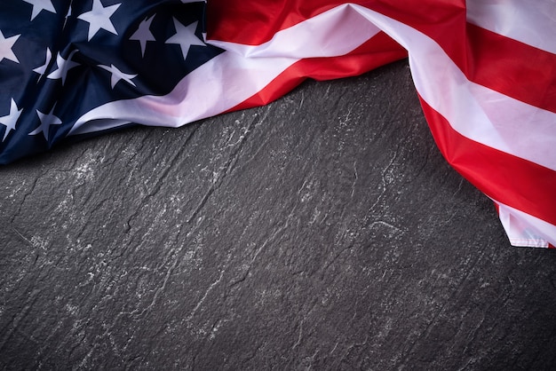 Concept of U.S Independence day or Memorial day. National flag over dark slate table background.