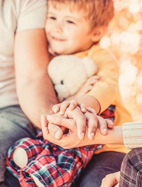 Concept of unity support protection happiness Child hand closeup into parents