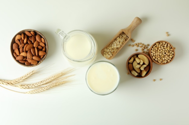 Concept of vegan milk on white background, top view