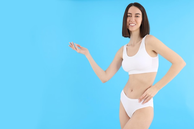 Concept of weight loss with thin girl on blue background