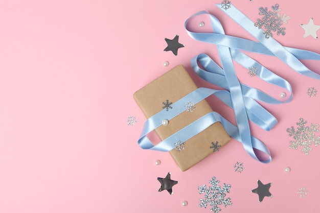 Concept of winter gift gift box and accessories on pink background