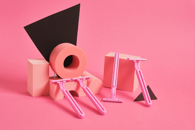 Concept of women's body care. pink razor on a pink background.