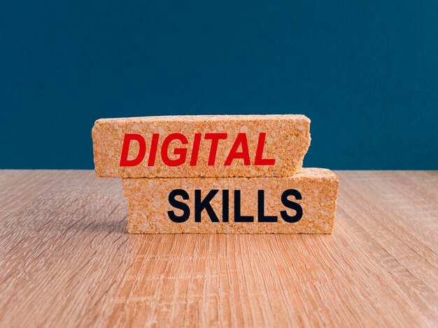 Photo concept words digital skills on brick blocks beautiful dark blue background wooden table