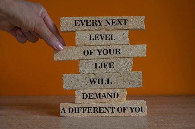 Concept words Every next level of your life will demand a different you Words on brick blocks