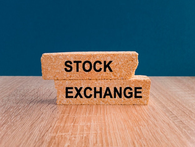 Concept words Stock exchange on brick blocks on a beautiful wooden table blue background