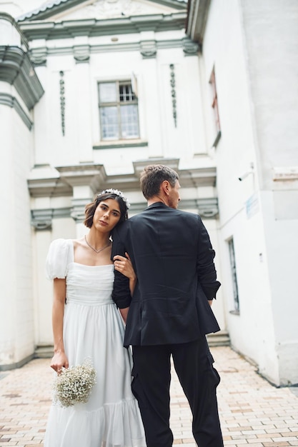 Conception of love Beautiful bride with his fiance is celebrating wedding outdoors