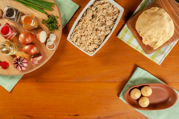 Conception of preparing brazilian snacks chiken croquette coxinha de frango Top view