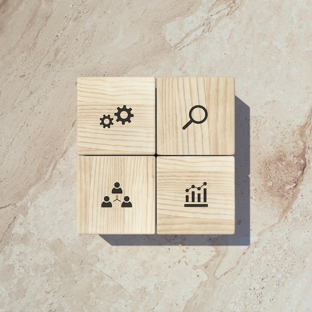 Conceptual business illustration with wooden cubes and icons on marble background