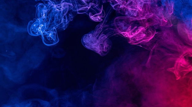 Conceptual image of colorful red and blue color smoke on dark black background