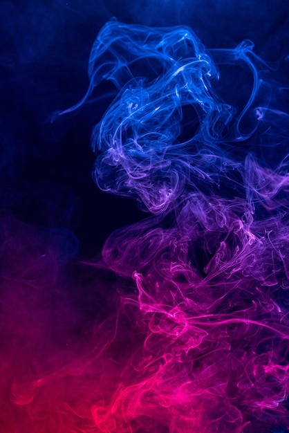 Conceptual image of colorful red and blue color smoke isolated on dark black background, Halloween concept design element.