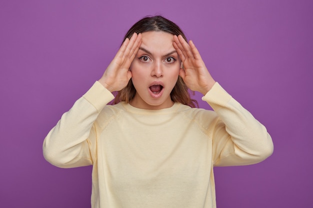 Concerned young girl keeping hands on head 