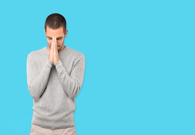 Concerned young man praying gesture