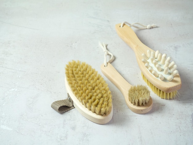 On a concrete background accessories for spa treatments brushes for face and body massage