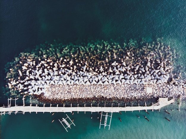 Concrete breakwaters Seascape with concrete tetrapodes to protect coastal structures from destructive impact of storm sea waves Tetrapods concrete blocks Strengthening of concrete sea Breakwater