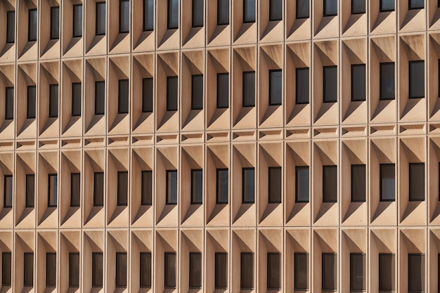 Concrete building facade with raised windows