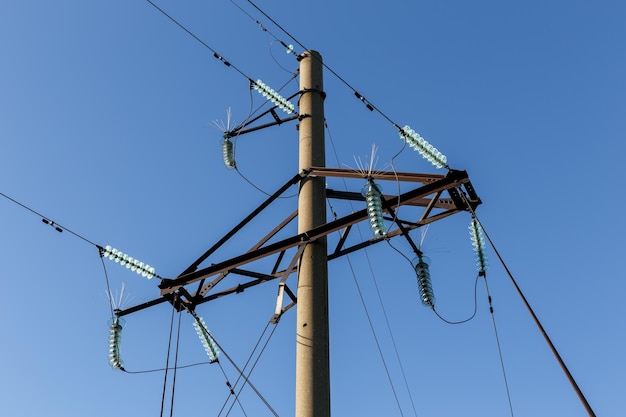 Concrete electricity pylon with glass insulators and bird spikes electric concept bird protect