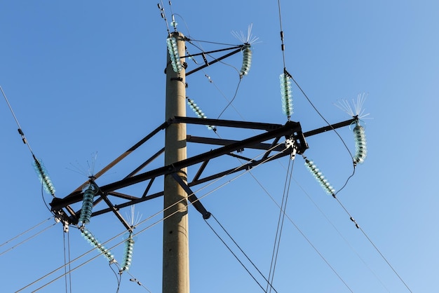 Concrete electricity pylon with glass insulators and bird spikes electric power concept