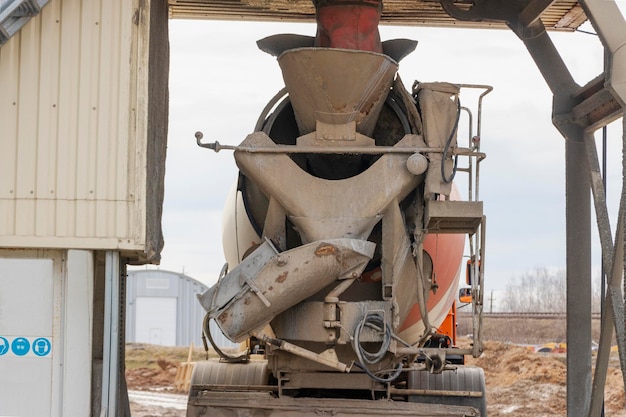 Concrete mixer truck loads concrete at the factory Transportation of concrete to the construction site Construction equipment for the delivery of concrete