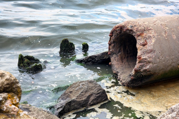 Concrete pipe on river coast