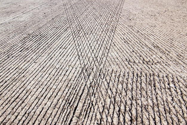 Concrete road surface with skid resistance lines as background