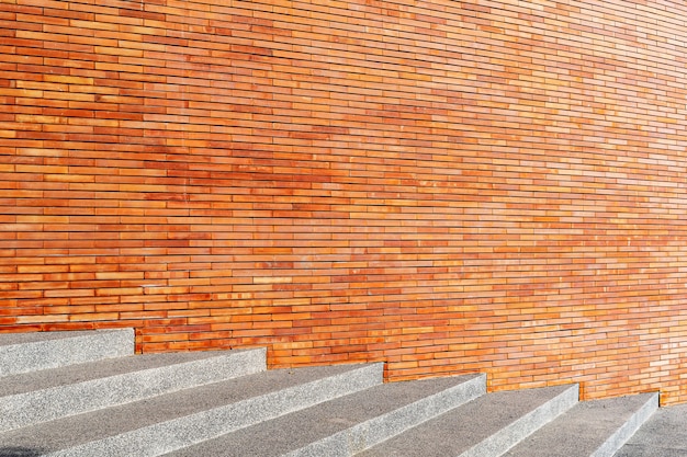 Concrete stairs and red wall with free space. Abstract background. Building and construction backdrop.