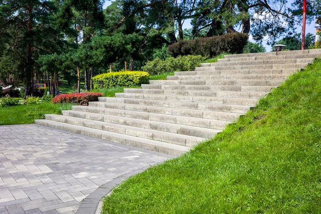 Concrete steps in a landscape recreation park with bushes